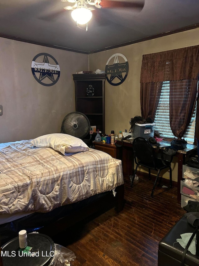 bedroom featuring ornamental molding, dark wood-type flooring, and ceiling fan