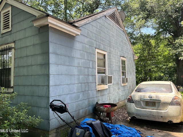 view of side of home featuring cooling unit