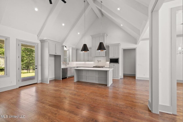 kitchen featuring beamed ceiling, a kitchen island, appliances with stainless steel finishes, and high vaulted ceiling