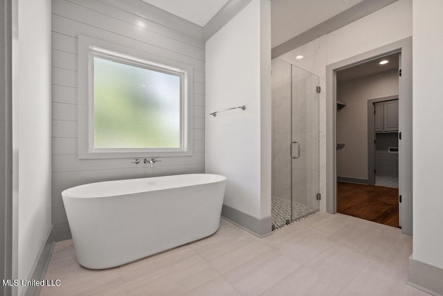 bathroom featuring shower with separate bathtub