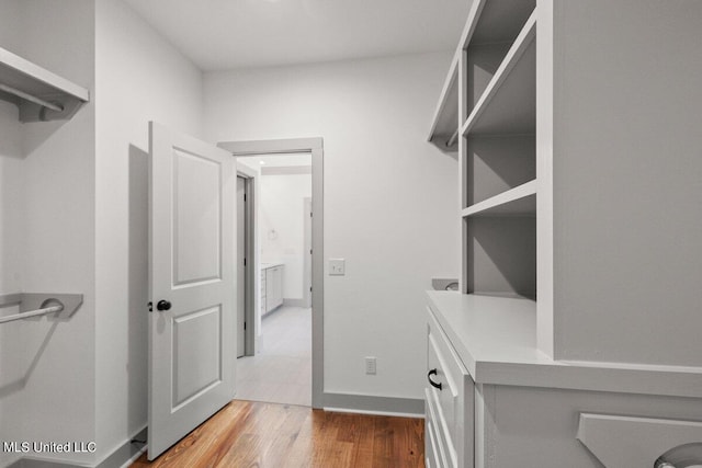 spacious closet featuring hardwood / wood-style flooring