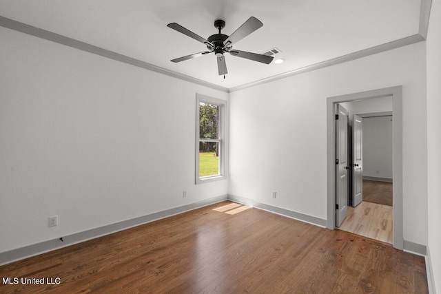 unfurnished bedroom featuring ceiling fan, wood-type flooring, and ornamental molding