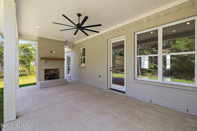 view of patio / terrace with an outdoor brick fireplace and ceiling fan