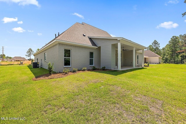 rear view of house with ceiling fan, a yard, a patio, and central AC