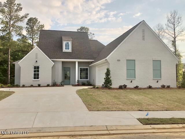 view of front of home with a front yard and a garage