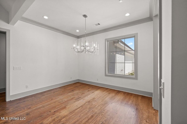 unfurnished dining area featuring a notable chandelier and hardwood / wood-style flooring