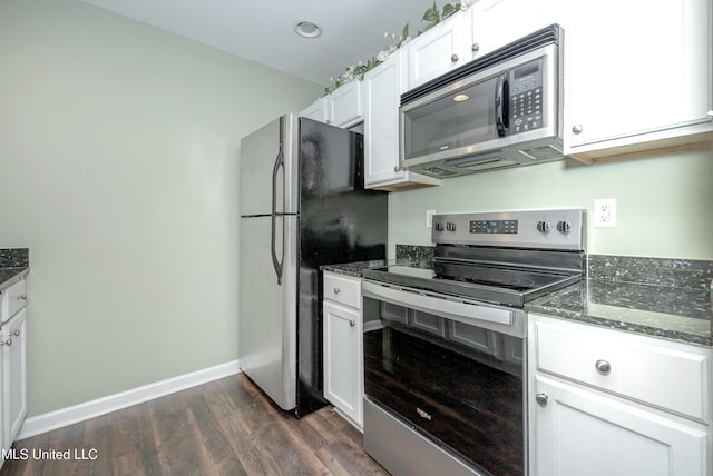 2421 Beachview Dr Unit H2, Ocean Springs, MS 39564 - kitchen featuring stainless steel appliances, dark wood-type flooring, white cabinets, dark stone countertops, and baseboards