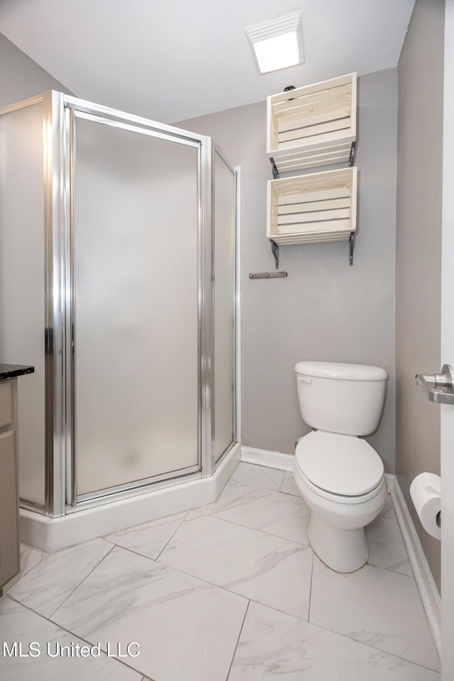 2421 Beachview Dr Unit H2, Ocean Springs, MS 39564 - bathroom featuring marble look tile flooring, a shower stall, and toilet