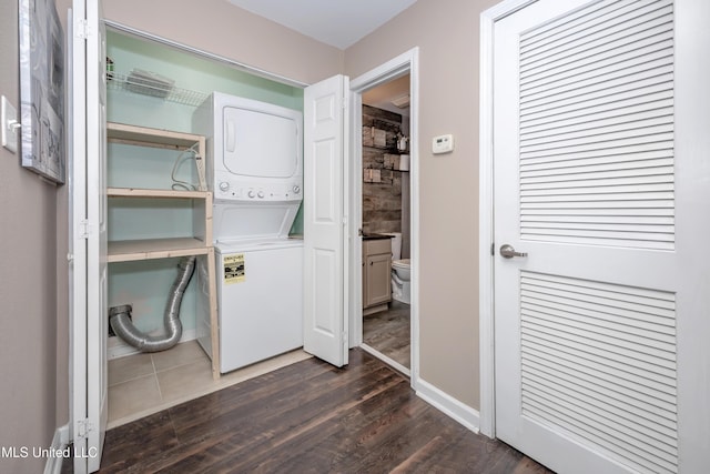 2421 Beachview Dr Unit H2, Ocean Springs, MS 39564 - laundry area featuring stacked washer / drying machine, dark wood-style flooring, and baseboards