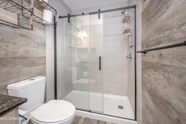 2421 Beachview Dr Unit H2, Ocean Springs, MS 39564 - bathroom featuring vanity, toilet, a stall shower, and wood finished floors