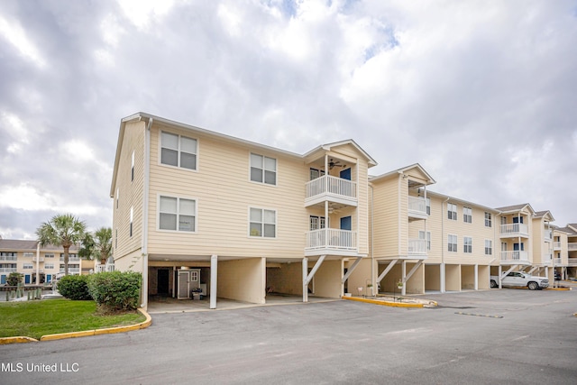 2421 Beachview Dr Unit H2, Ocean Springs, MS 39564 - view of building exterior featuring covered and uncovered parking