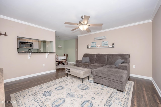 2421 Beachview Dr Unit H2, Ocean Springs, MS 39564 - living area featuring wood finished floors, ornamental molding, a ceiling fan, and baseboards