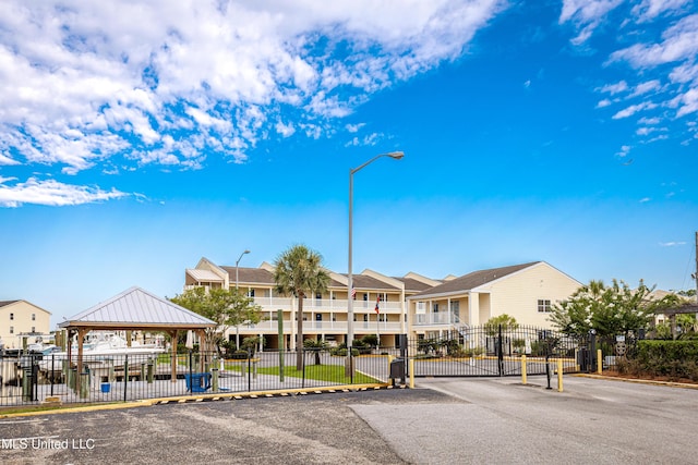 2421 Beachview Dr Unit H2, Ocean Springs, MS 39564 - view of building exterior featuring fence and a residential view