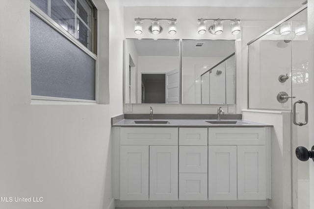 bathroom featuring an enclosed shower and vanity