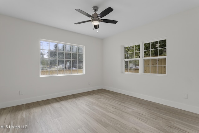 unfurnished room featuring light wood-type flooring and ceiling fan