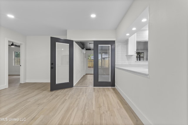 interior space with french doors and light hardwood / wood-style flooring