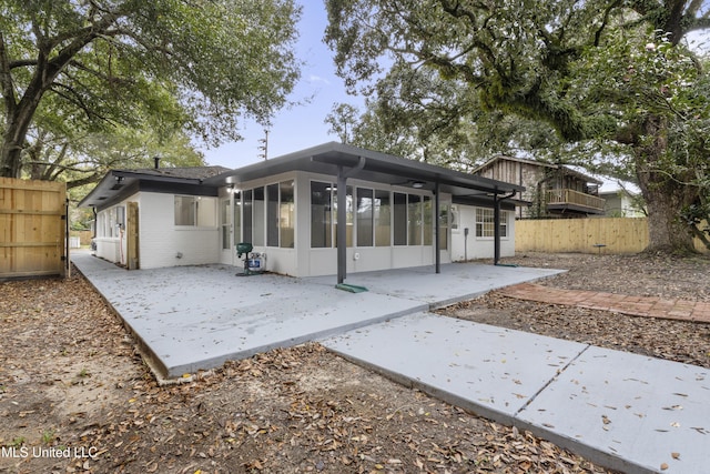 back of house with a patio area and a sunroom