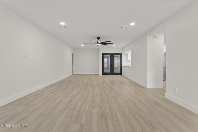 unfurnished living room with french doors, ceiling fan, and light hardwood / wood-style floors