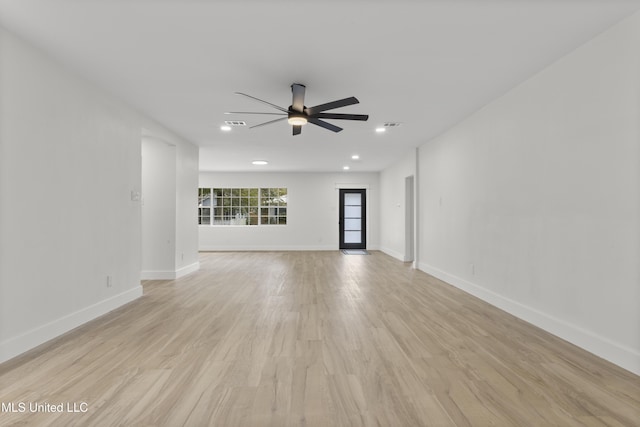 unfurnished living room featuring ceiling fan and light hardwood / wood-style flooring