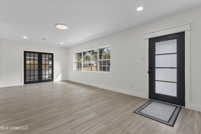 foyer featuring french doors and light hardwood / wood-style floors