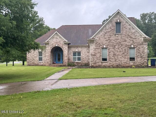 4343 Sharon Dr, Horn Lake, MS 38637 - view of front of house featuring a front yard and brick siding