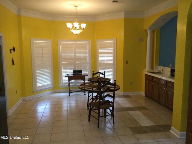 4343 Sharon Dr, Horn Lake, MS 38637 - dining space featuring plenty of natural light, arched walkways, light tile patterned floors, ornate columns, and crown molding