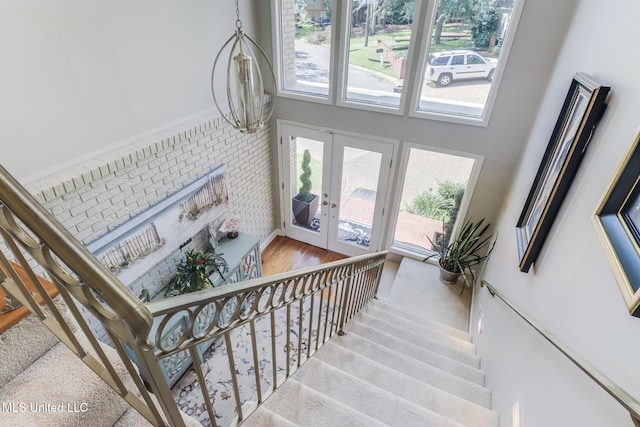 435 Christi Ln, Biloxi, MS 39531 - stairway featuring french doors, healthy amount of natural light, wood finished floors, and a towering ceiling