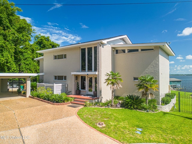 435 Christi Ln, Biloxi, MS 39531 - view of front of property featuring a carport, driveway, brick siding, and a water view