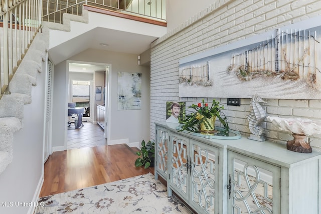 435 Christi Ln, Biloxi, MS 39531 - hall featuring brick wall, wood finished floors, stairway, and recessed lighting