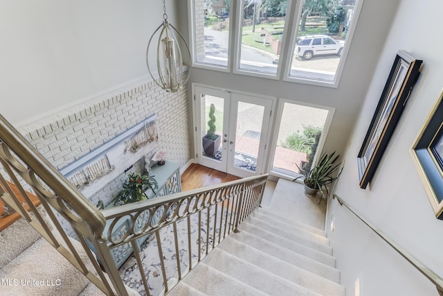 435 Christi Ln, Biloxi, MS 39531 - staircase featuring french doors, plenty of natural light, and wood finished floors