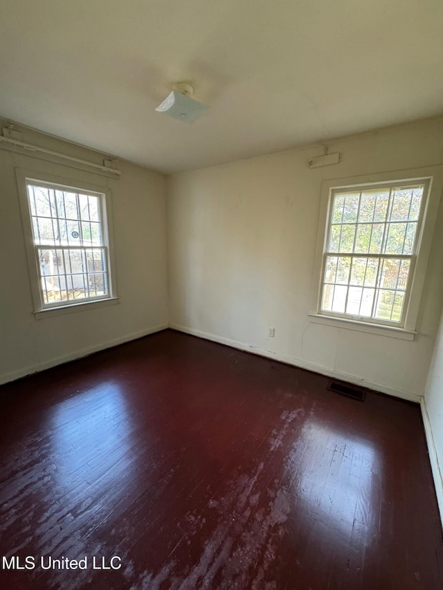 empty room featuring dark hardwood / wood-style flooring