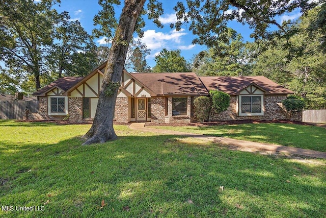 tudor home featuring a front lawn