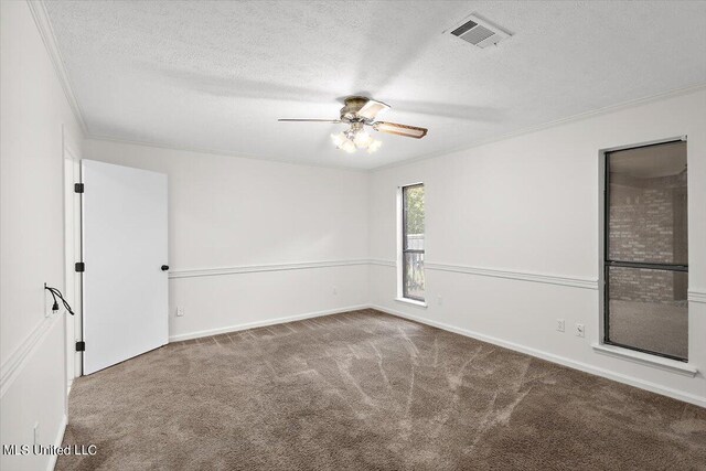 empty room with crown molding, carpet flooring, a textured ceiling, and ceiling fan