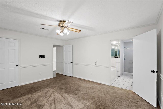 unfurnished bedroom featuring connected bathroom, ornamental molding, carpet flooring, a textured ceiling, and ceiling fan