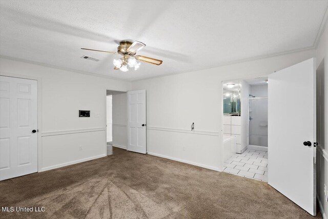 unfurnished bedroom with carpet, visible vents, ensuite bathroom, and crown molding