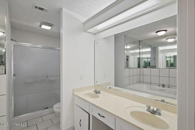 full bathroom with vanity, toilet, independent shower and bath, and a textured ceiling