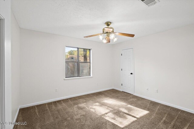 carpeted empty room with a textured ceiling and ceiling fan