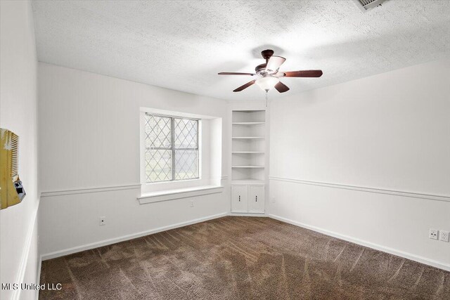 carpeted empty room with a textured ceiling and ceiling fan