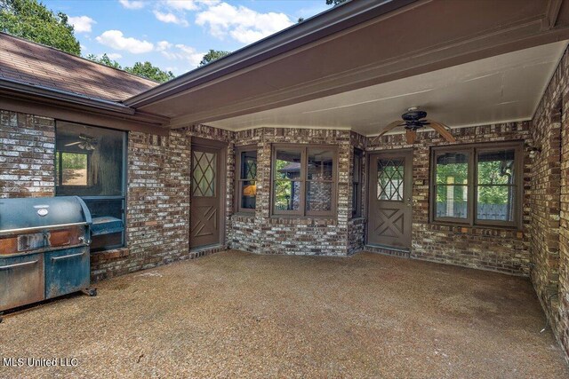 view of patio with ceiling fan, grilling area, and an outdoor kitchen