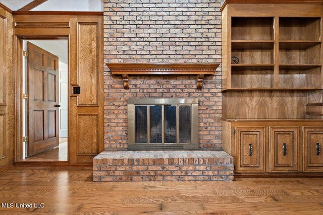unfurnished living room with wood finished floors and a fireplace