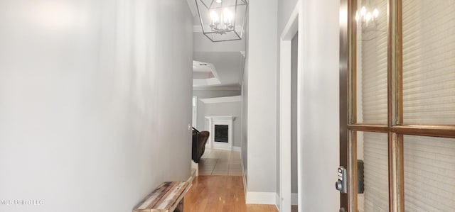 682 Hilo Way, Diamondhead, MS 39525 - corridor featuring a chandelier, light wood-style flooring, and crown molding