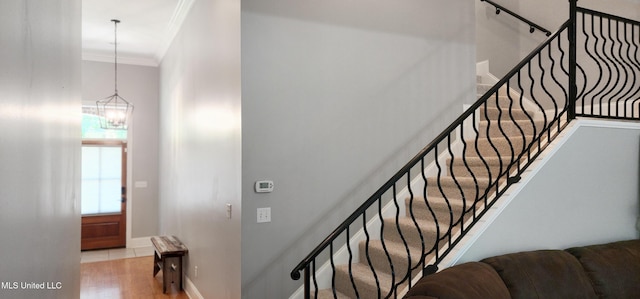 682 Hilo Way, Diamondhead, MS 39525 - staircase featuring ornamental molding, wood finished floors, and a chandelier