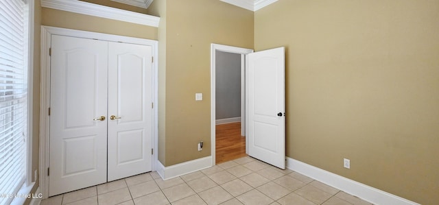 682 Hilo Way, Diamondhead, MS 39525 - unfurnished bedroom featuring ornamental molding, light tile patterned floors, and a closet