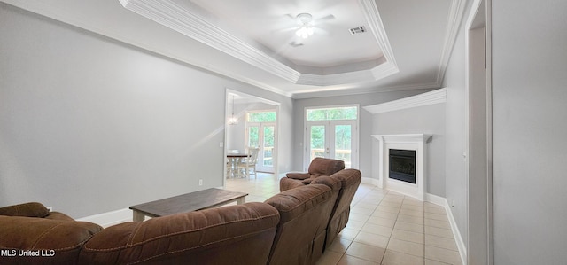 682 Hilo Way, Diamondhead, MS 39525 - living room with light tile patterned flooring, a fireplace, ornamental molding, a raised ceiling, and ceiling fan