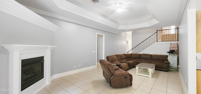 682 Hilo Way, Diamondhead, MS 39525 - living area with stairs, light tile patterned floors, a ceiling fan, a raised ceiling, and ornamental molding