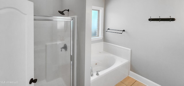 682 Hilo Way, Diamondhead, MS 39525 - bathroom with a stall shower, a bath, and tile patterned floors