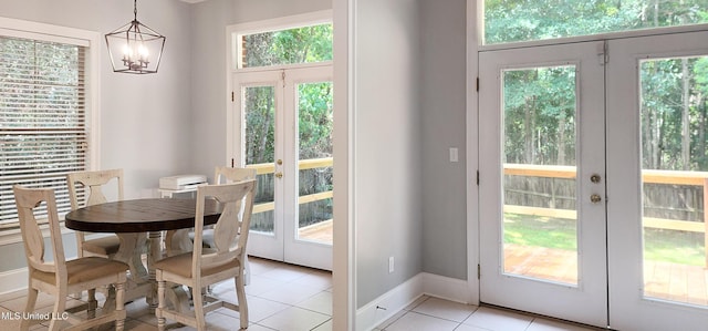 682 Hilo Way, Diamondhead, MS 39525 - dining room with french doors, light tile patterned flooring, healthy amount of natural light, and a chandelier