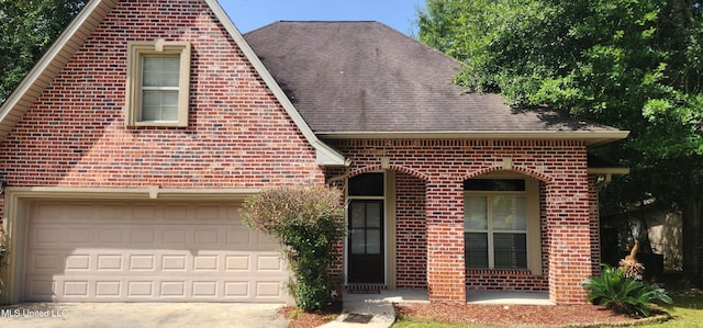 682 Hilo Way, Diamondhead, MS 39525 - view of front of house featuring brick siding, concrete driveway, a garage, and roof with shingles