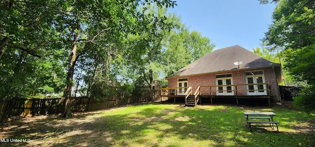 682 Hilo Way, Diamondhead, MS 39525 - rear view of house featuring french doors, brick siding, and a deck