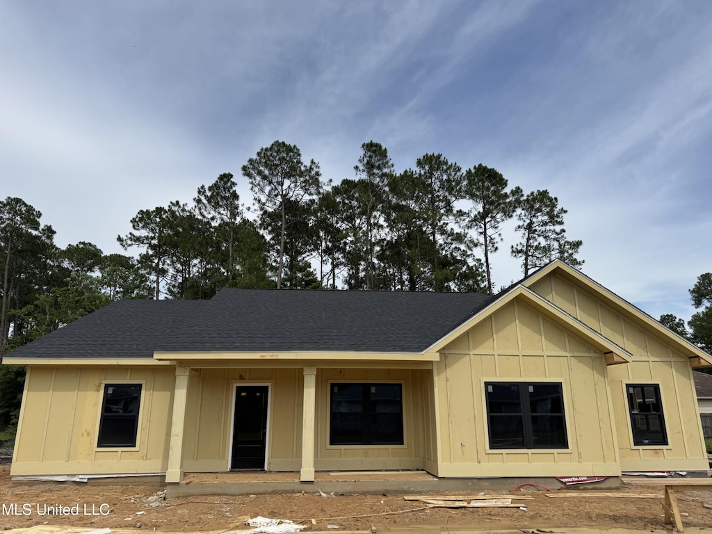 832 Combel St, Waveland, MS 39576 - view of front of house with board and batten siding and a shingled roof